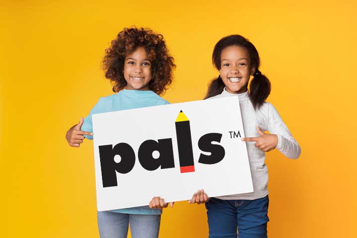 Two girls holding a paper sign with the PALS logo.
