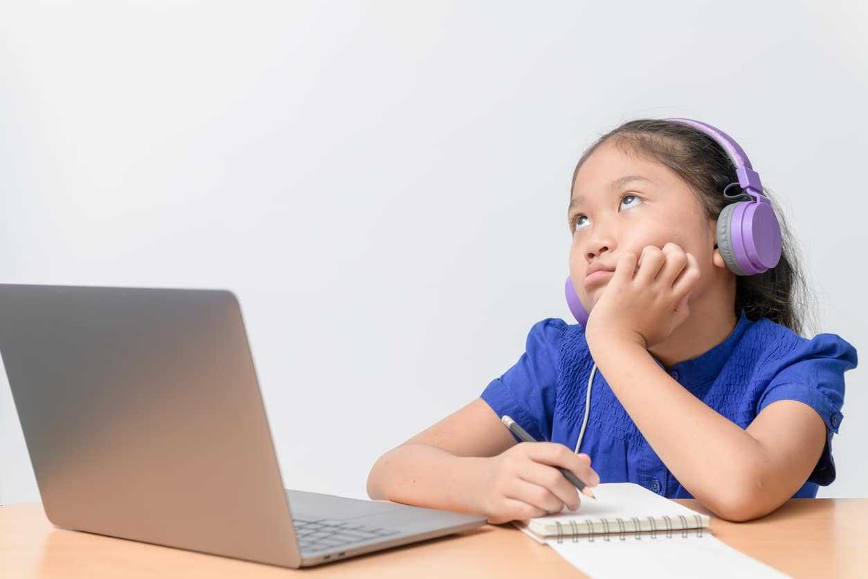 School girl watching online education classes feeling bored and depressed at home